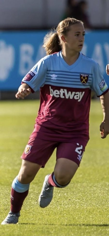 Wiktoria aged 16 running with the ball in a West Ham kit